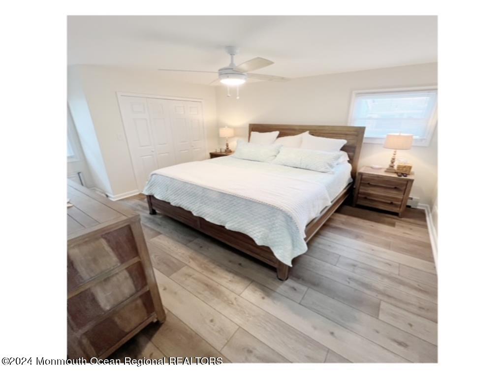 308 Harding Avenue, Unit WKLY SUMMER RENTAL Seaside Heights, NJ 08751 - Photo 13 of 25 a bedroom with a bed and a night stand