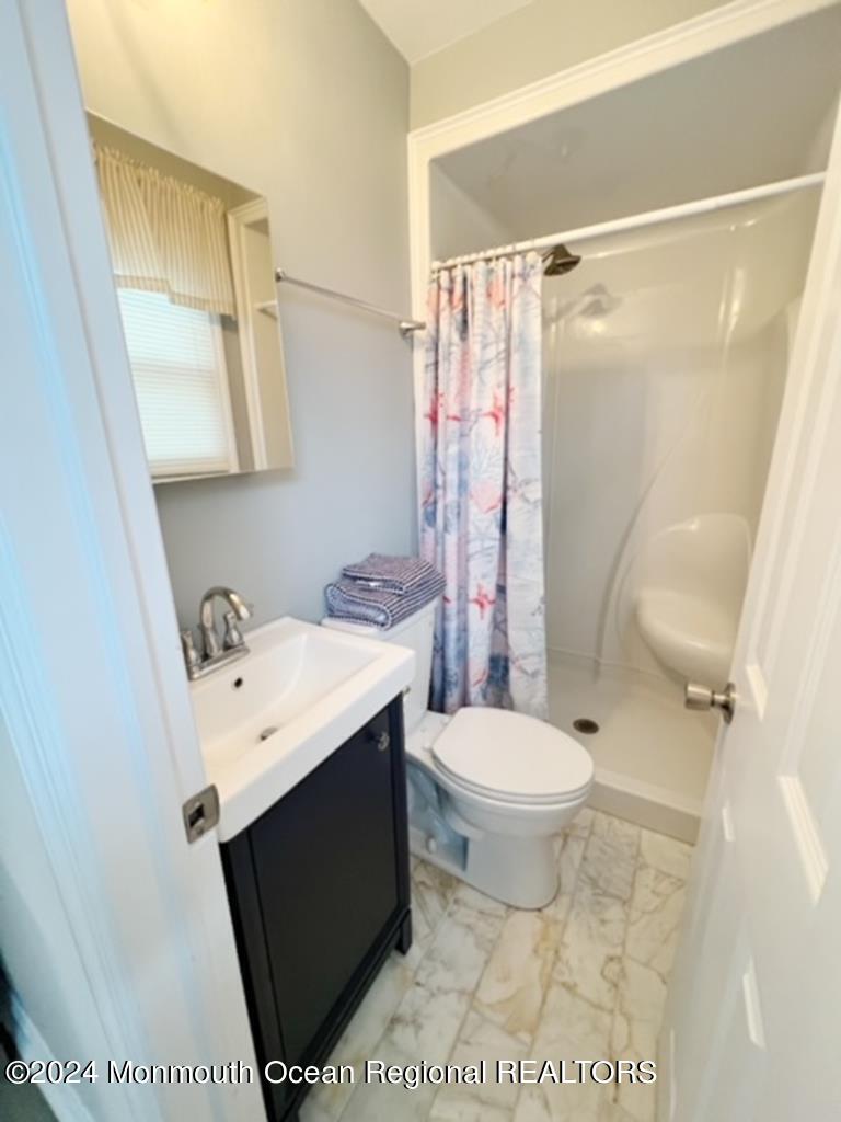 308 Harding Avenue, Unit WKLY SUMMER RENTAL Seaside Heights, NJ 08751 - Photo 14 of 25 a bathroom with a sink toilet and shower