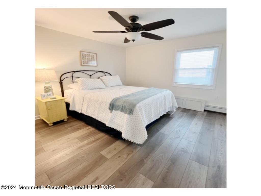 308 Harding Avenue, Unit WKLY SUMMER RENTAL Seaside Heights, NJ 08751 - Photo 15 of 25 a bed room with a bed and a window