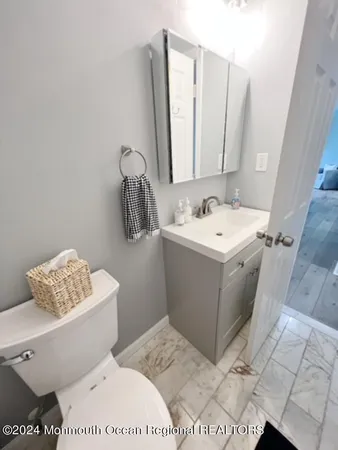 a bathroom with a sink toilet and mirror