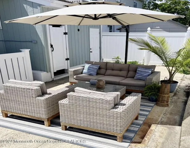 a view of a patio with couches and potted plants