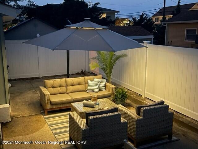 308 Harding Avenue, Unit WKLY SUMMER RENTAL Seaside Heights, NJ 08751 - Photo 23 of 25 a backyard of a house with table and chairs