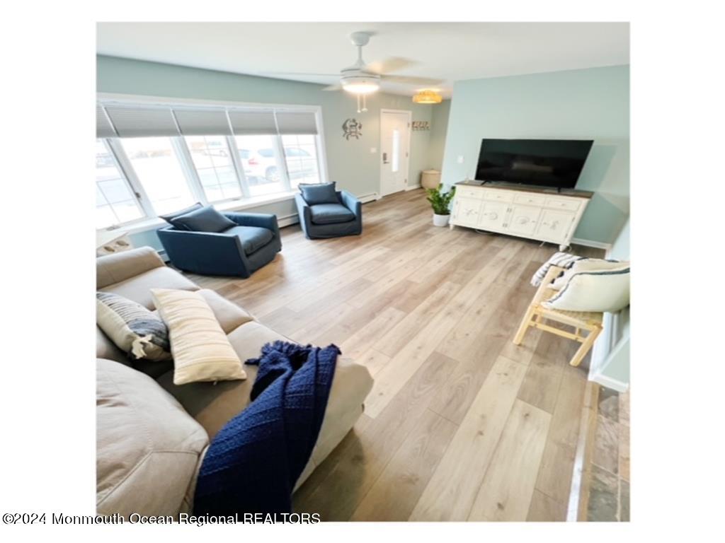 308 Harding Avenue, Unit WKLY SUMMER RENTAL Seaside Heights, NJ 08751 - Photo 8 of 25 a living room with furniture and a flat screen tv