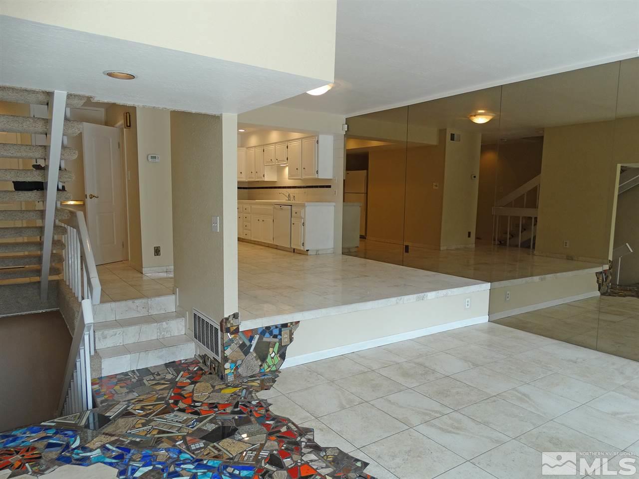 1336 Jones Street Reno, NV 89503 - Photo 4 of 24 a view of a refrigerator in kitchen and dining room with wooden floor
