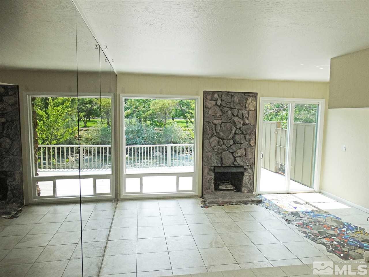 1336 Jones Street Reno, NV 89503 - Photo 7 of 24 a view of an empty room with a fireplace and a window