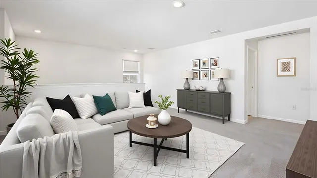 a living room with furniture and a potted plant