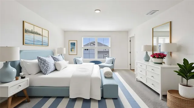 a bedroom with a bed and a potted plant