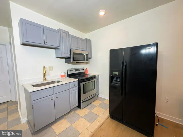 a kitchen with a refrigerator and cabinets