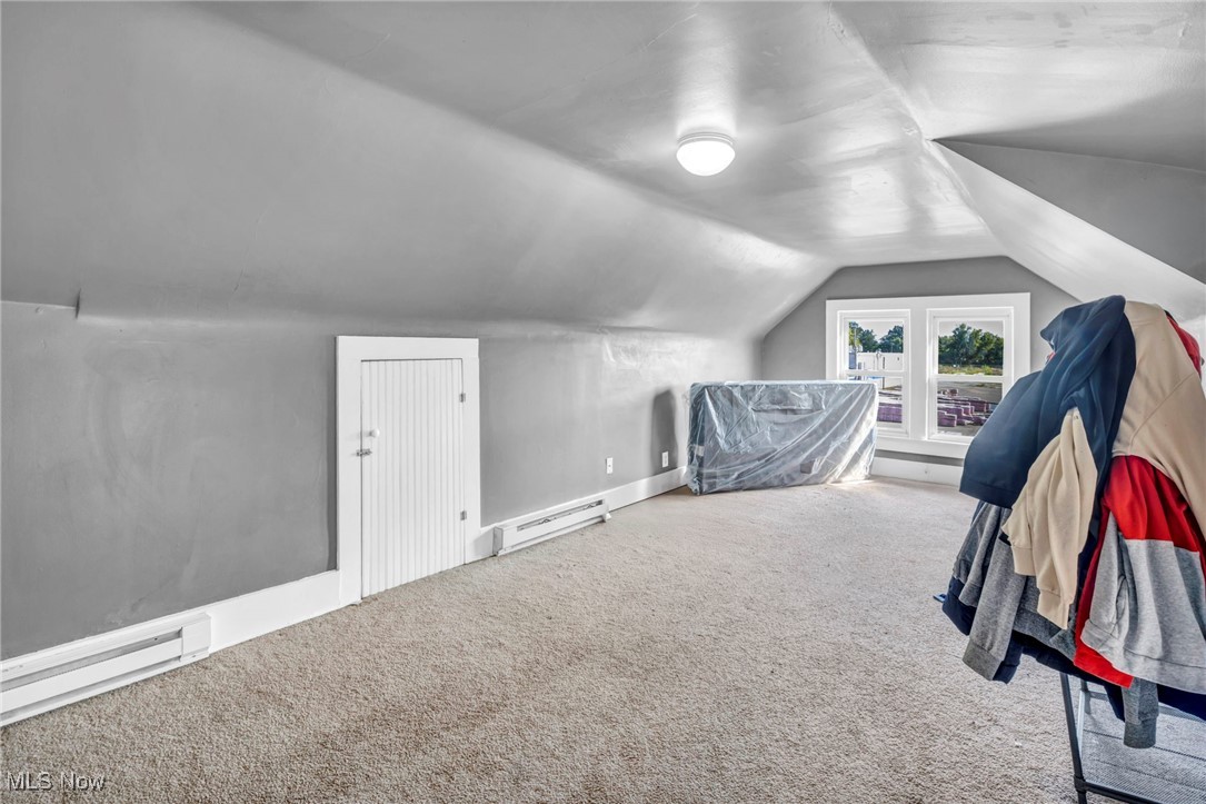 1107 West Wilbeth Road Akron, OH 44314 - Photo 22 of 50 Bonus room featuring lofted ceiling, carpet, and baseboard heating