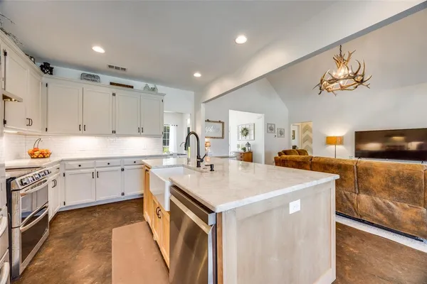 a kitchen with a sink appliances and cabinets
