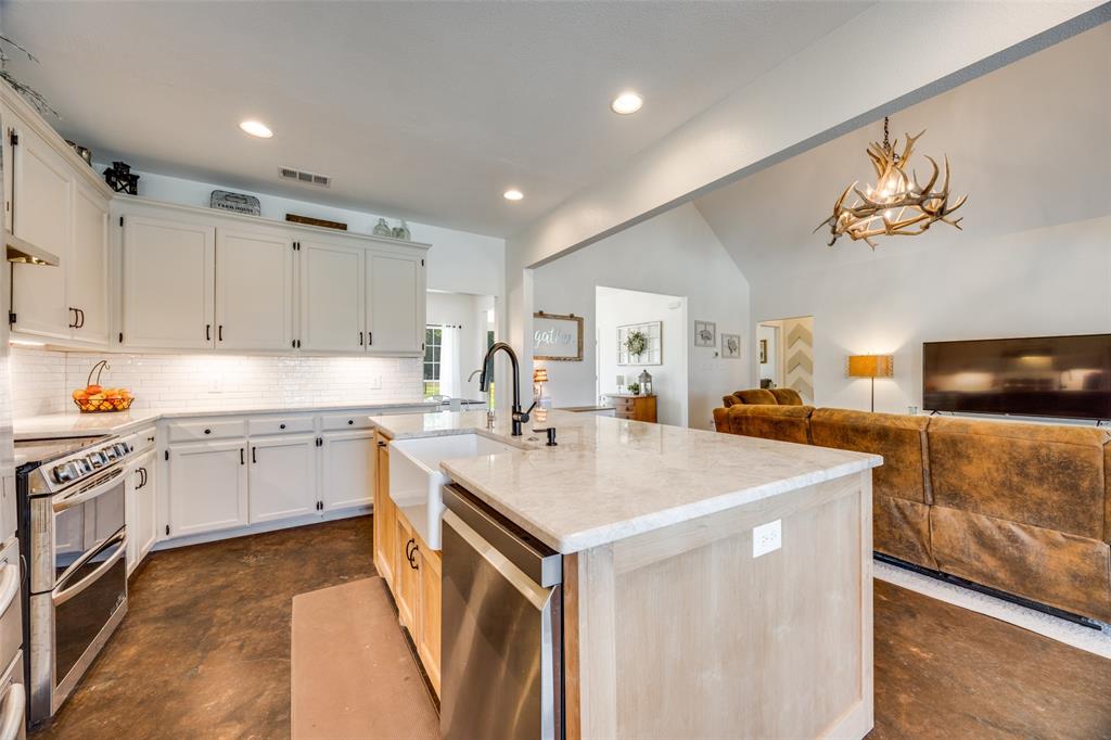 a kitchen with a sink appliances and cabinets