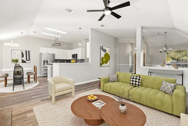 a living room with furniture and a wooden floor