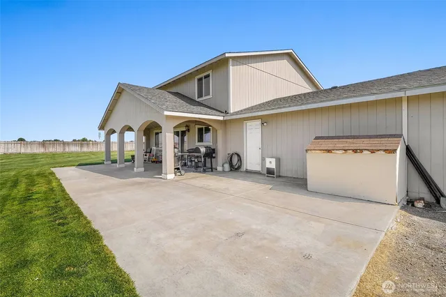 a view of a house with backyard porch and sitting area