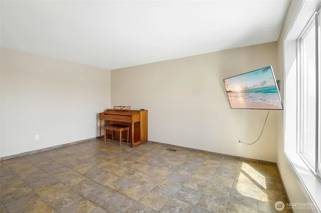 a kitchen with stainless steel appliances a stove a sink a refrigerator and a dining table with wooden floor