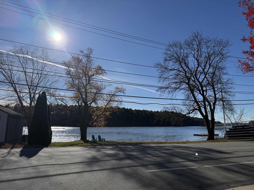 3 Laurel Place Amesbury, MA 01913 - Photo 8 of 14 a street view with wooden fence and trees