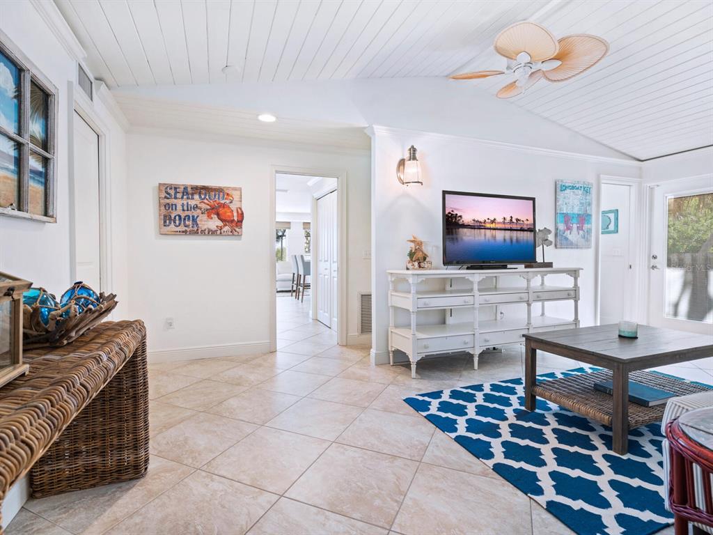 18 North Casey Key Road Osprey, FL 34229 - Photo 19 of 49 a living room with furniture and a flat screen tv