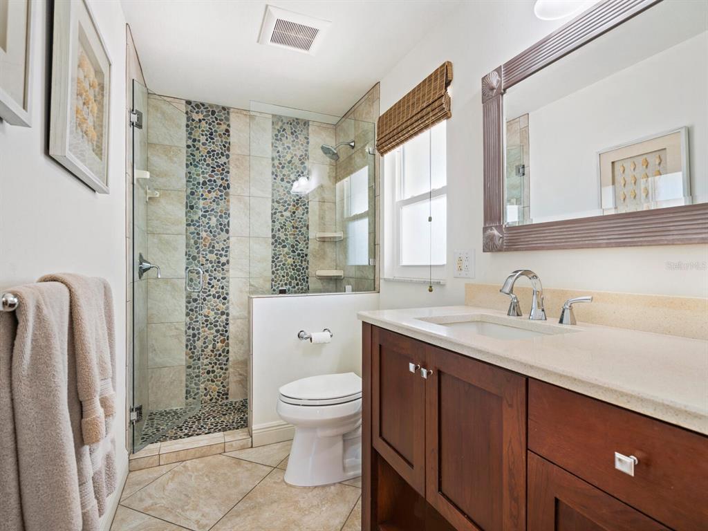 18 North Casey Key Road Osprey, FL 34229 - Photo 22 of 49 a bathroom with a granite countertop sink toilet and shower