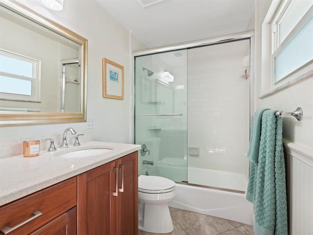 18 North Casey Key Road Osprey, FL 34229 - Photo 24 of 49 a bathroom with a sink a toilet and shower