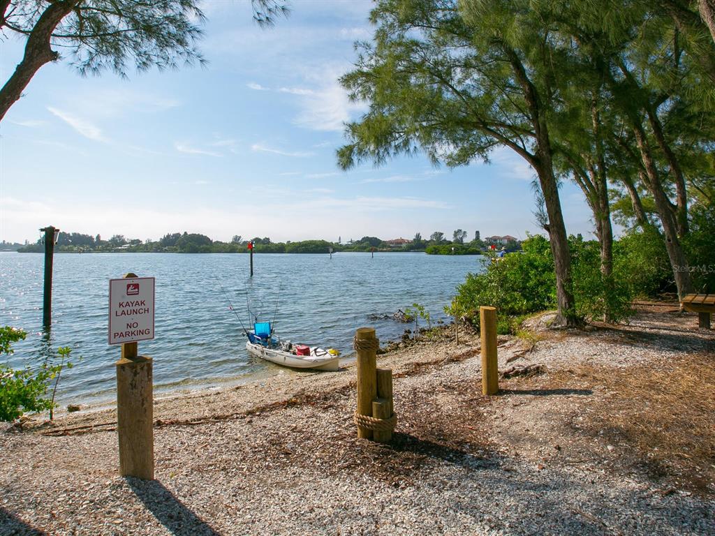 18 North Casey Key Road Osprey, FL 34229 - Photo 45 of 49 a view of a lake with a table under an umbrella