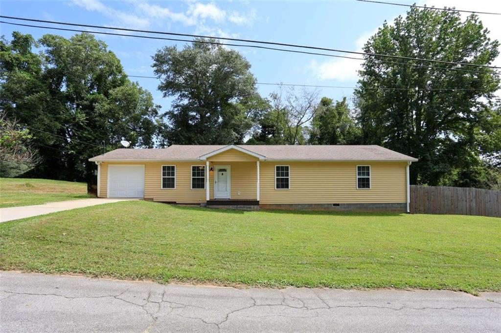 a house that has a tree in front of it