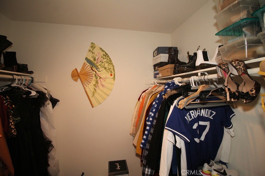 924 Condor Street Barstow, CA 92311 - Photo 36 of 52 a view of walk in closet with clothes