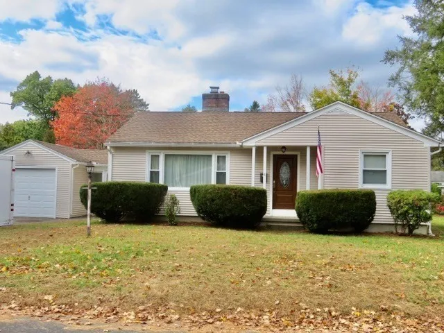 a front view of a house with a garden