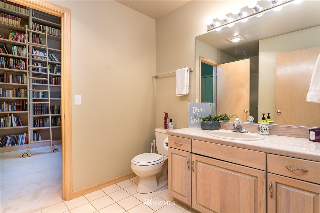 5520 Canvasback Road Blaine, WA 98230 - Photo 18 of 31 a bathroom with a double vanity sink a toilet and a mirror