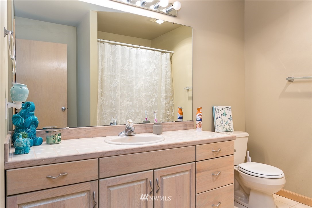 5520 Canvasback Road Blaine, WA 98230 - Photo 23 of 31 a bathroom with a sink and a mirror