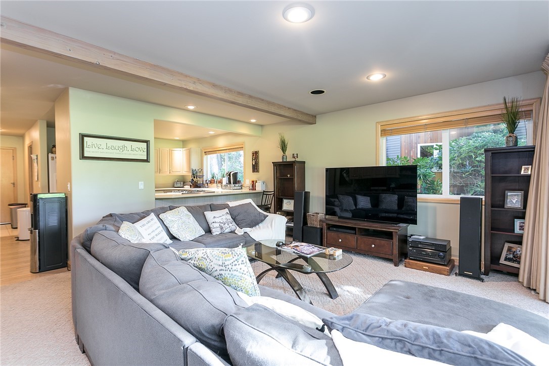 5520 Canvasback Road Blaine, WA 98230 - Photo 26 of 31 a living room with furniture a flat screen tv and a fireplace