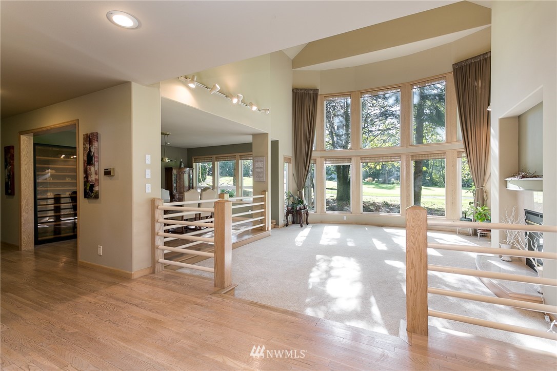 5520 Canvasback Road Blaine, WA 98230 - Photo 4 of 31 a view of a hall way with wooden floor and windows