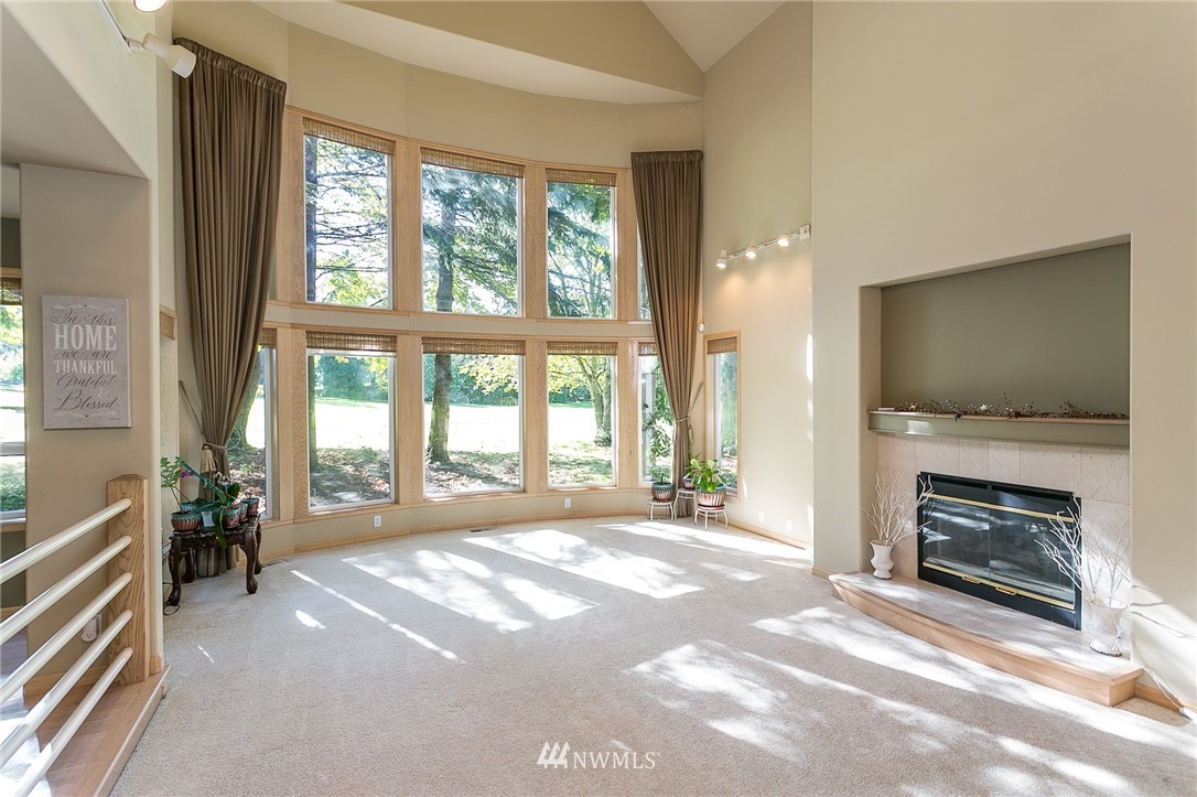 5520 Canvasback Road Blaine, WA 98230 - Photo 8 of 31 a view of an empty room with furniture and a fireplace