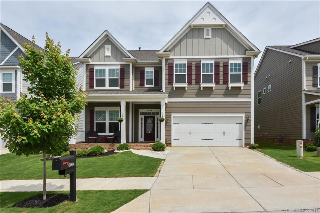 6004 Fallondale Road, Unit 881 Waxhaw, NC 28173 - Photo 2 of 20 a view of a white house with a yard and plants