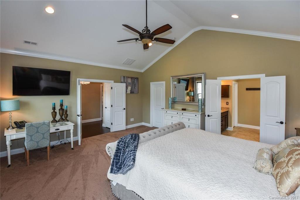 6004 Fallondale Road, Unit 881 Waxhaw, NC 28173 - Photo 12 of 20 a bedroom with a bed and a flat screen tv