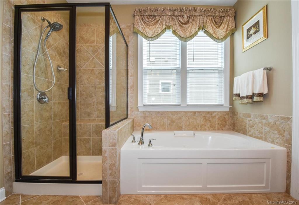 6004 Fallondale Road, Unit 881 Waxhaw, NC 28173 - Photo 14 of 20 a white bath tub sitting next to a window