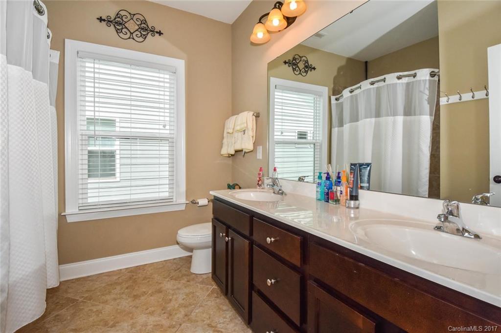 6004 Fallondale Road, Unit 881 Waxhaw, NC 28173 - Photo 15 of 20 a bathroom with a double vanity sink toilet and a mirror