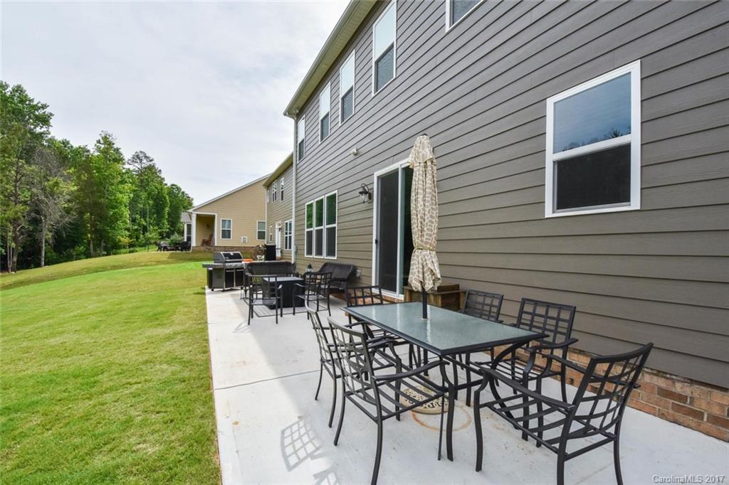 6004 Fallondale Road, Unit 881 Waxhaw, NC 28173 - Photo 16 of 20 a view of backyard of a house with table and chairs