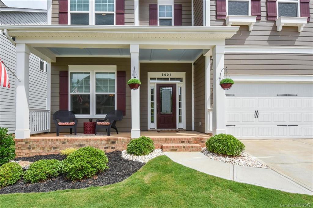 6004 Fallondale Road, Unit 881 Waxhaw, NC 28173 - Photo 3 of 20 a view of a house with backyard sitting area and garden