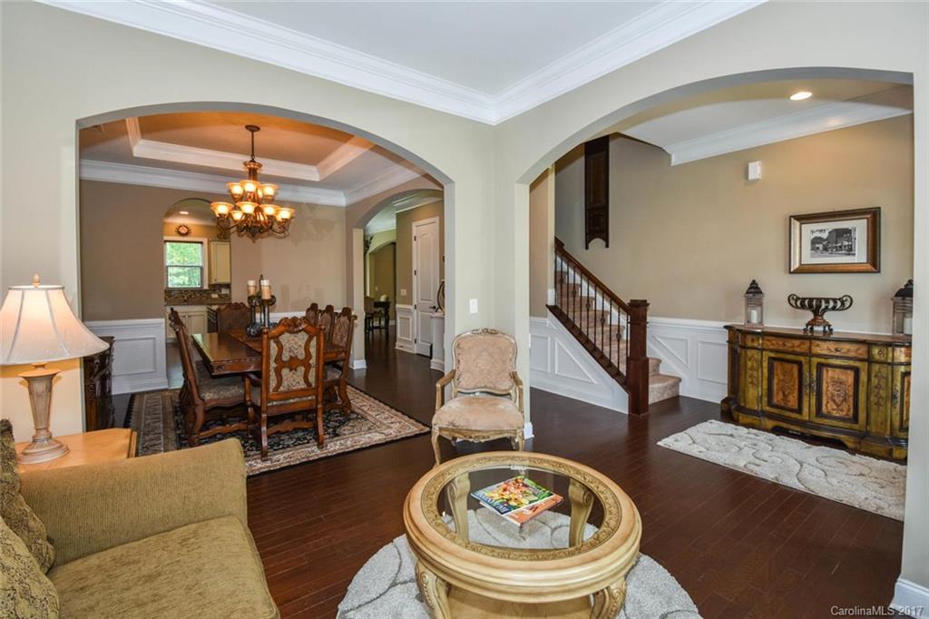 6004 Fallondale Road, Unit 881 Waxhaw, NC 28173 - Photo 5 of 20 a living room with furniture and a chandelier