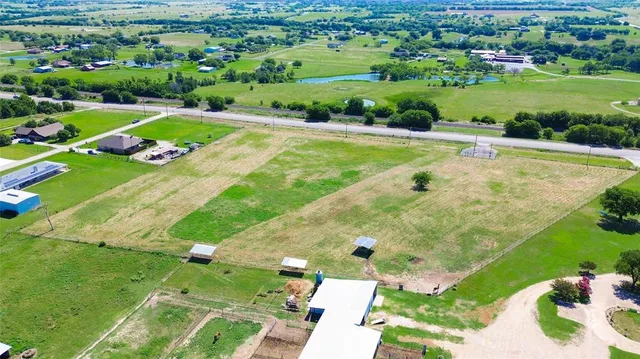 an aerial view of a house with a big yard