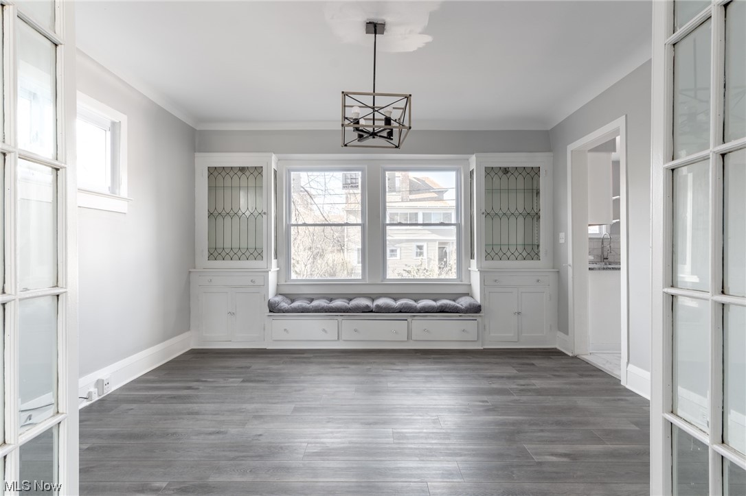 1228 Melbourne Road Cleveland, OH 44112 - Photo 6 of 35 Empty room with dark hardwood / wood-style floors and a notable chandelier
