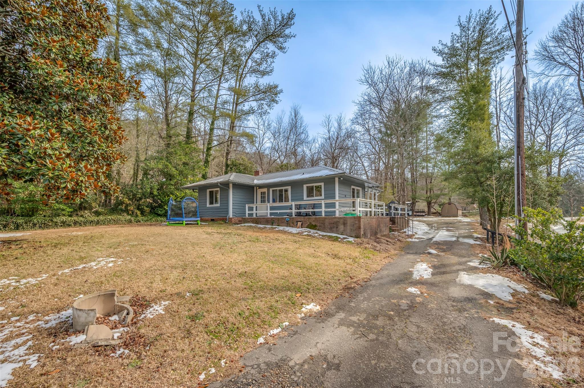 1685 Lynn Road Columbus, NC 28722 - Photo 2 of 31 a front view of house with yard space and trees around