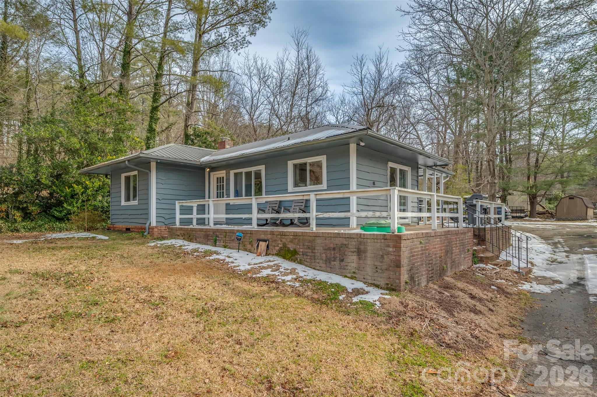 1685 Lynn Road Columbus, NC 28722 - Photo 3 of 31 a front view of a house with a yard and garage