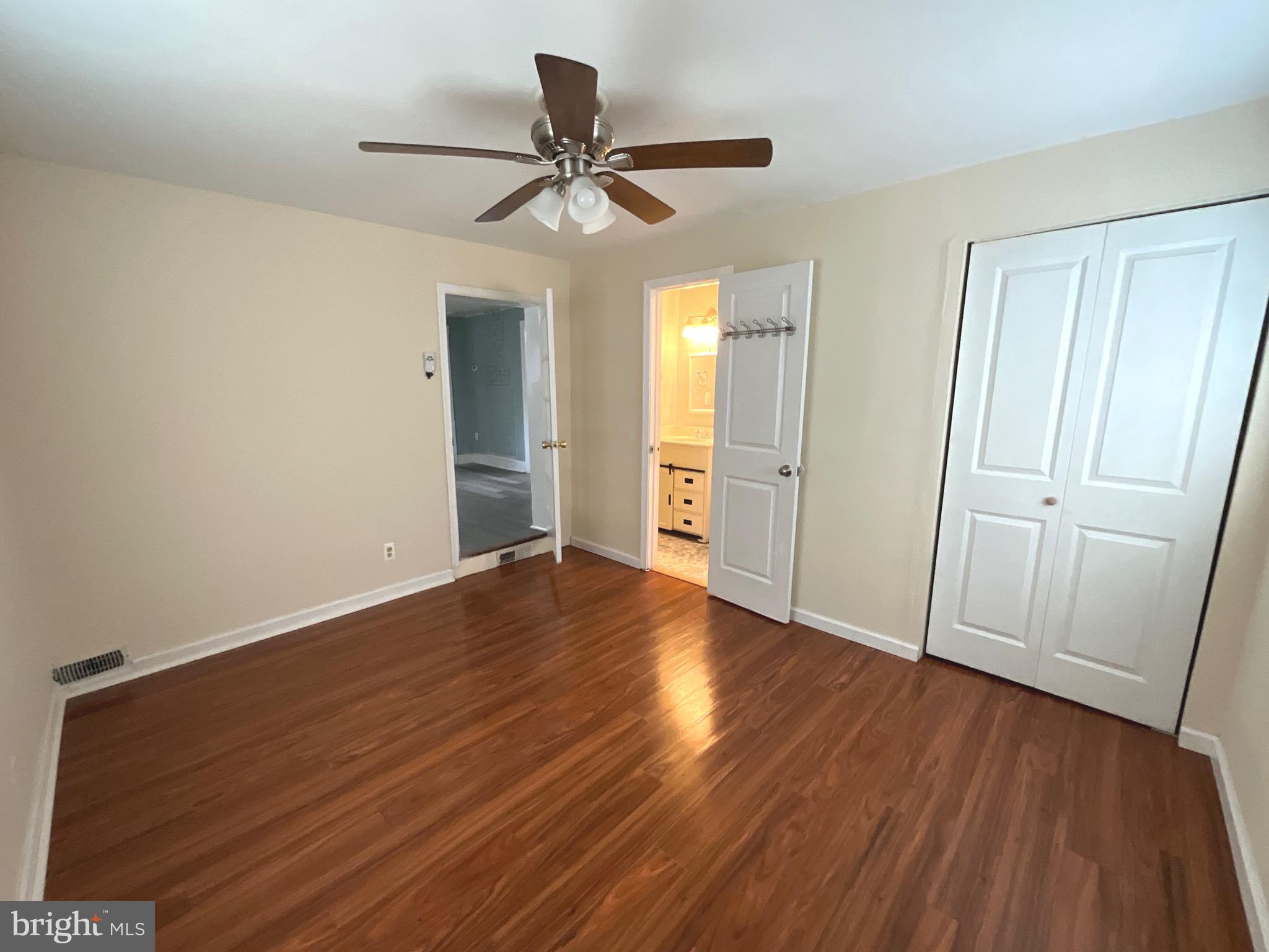 86 Kelley Road Fredericksburg, VA 22405 - Photo 18 of 36 a view of a livingroom with wooden floor and a ceiling fan
