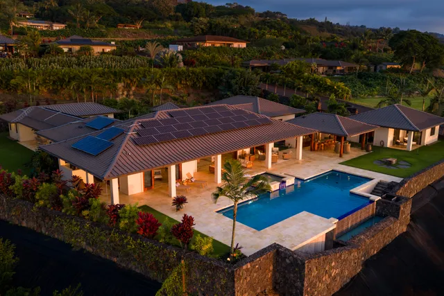 an aerial view of a house with pool garden and outdoor seating