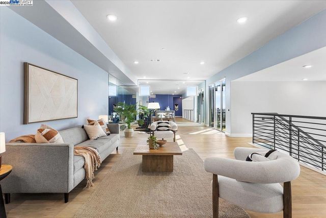 a room with lots of furniture and potted plants