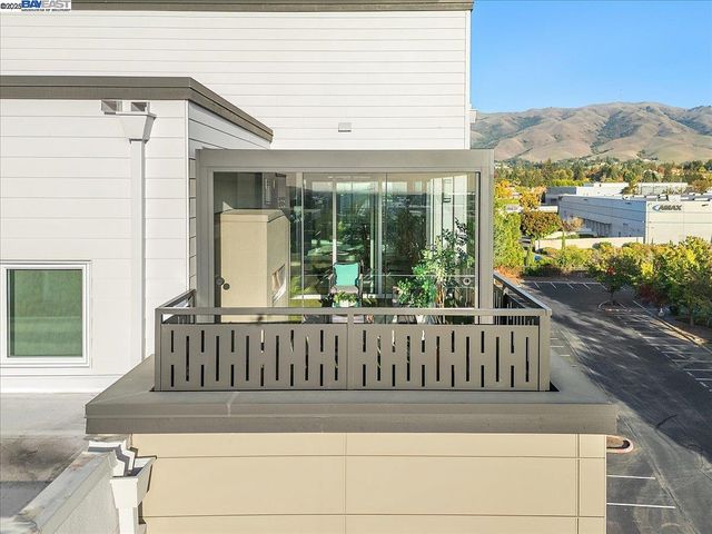 a view of a swimming pool with lawn chairs and potted plants