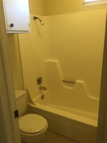 619 West 37th Street, Unit 101 Austin, TX 78705 - Photo 12 of 14 a bathroom with a toilet and a shower