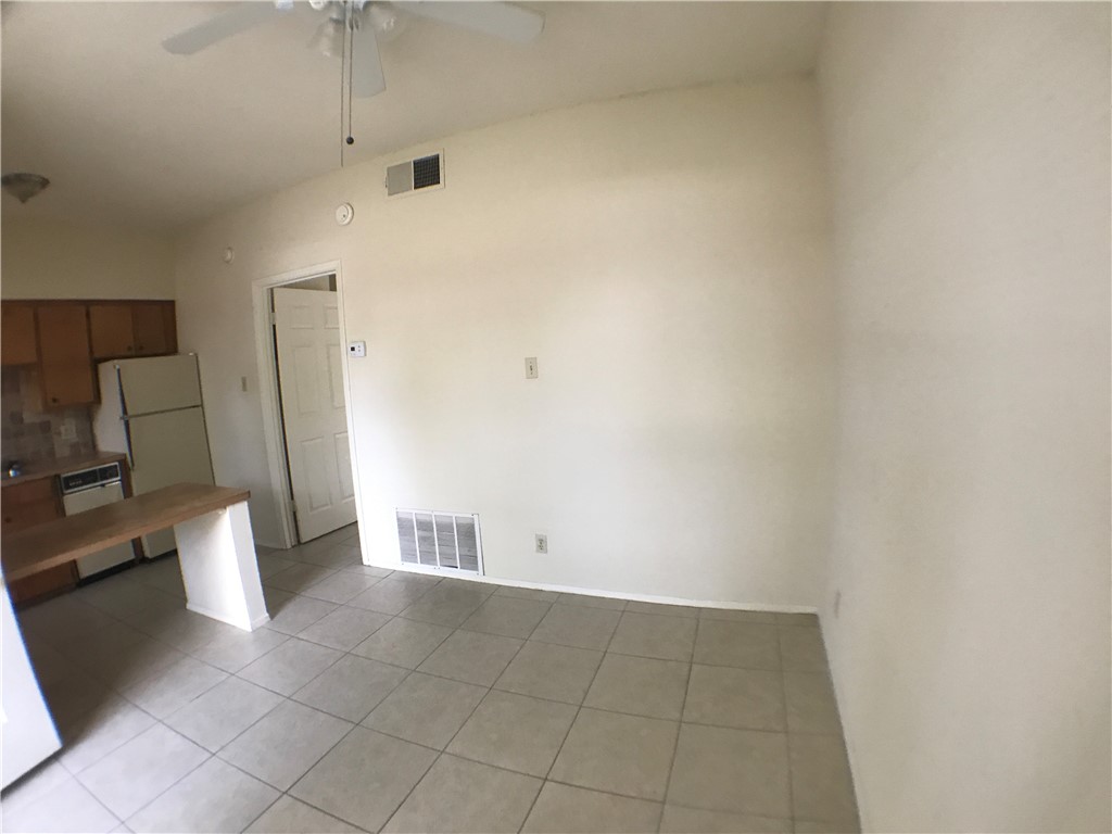 619 West 37th Street, Unit 101 Austin, TX 78705 - Photo 3 of 14 an empty room with a rug and a window