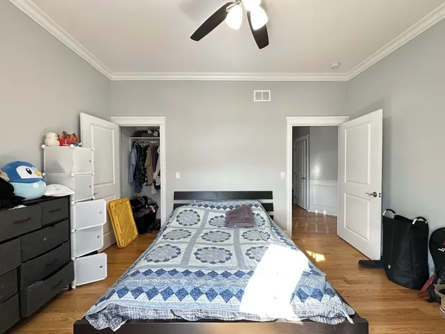 a bedroom with a bed and a dresser in it