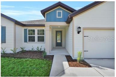 4451 Southwest 160 Loop Ocala, FL 34473 - Photo 3 of 15 a front view of a house with a yard